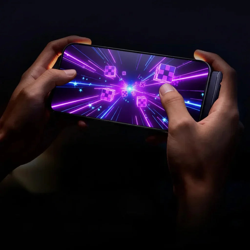 Person playing a vibrant neon mobile game on a smartphone in a dark setting